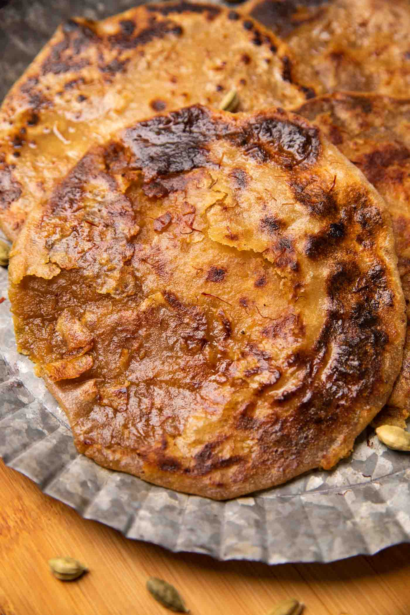 Puran polis served on a silver platter drizzled with saffron and ghee
