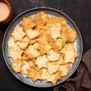 Air Fryer papdi served on a plate with chai on the side
