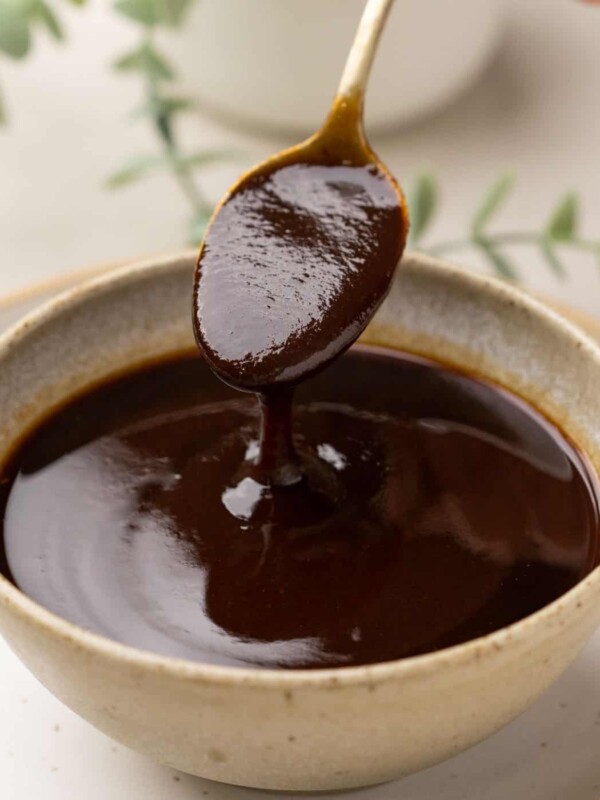 Tamarind Chutney being poured from a spoon into a bowl to show the texture