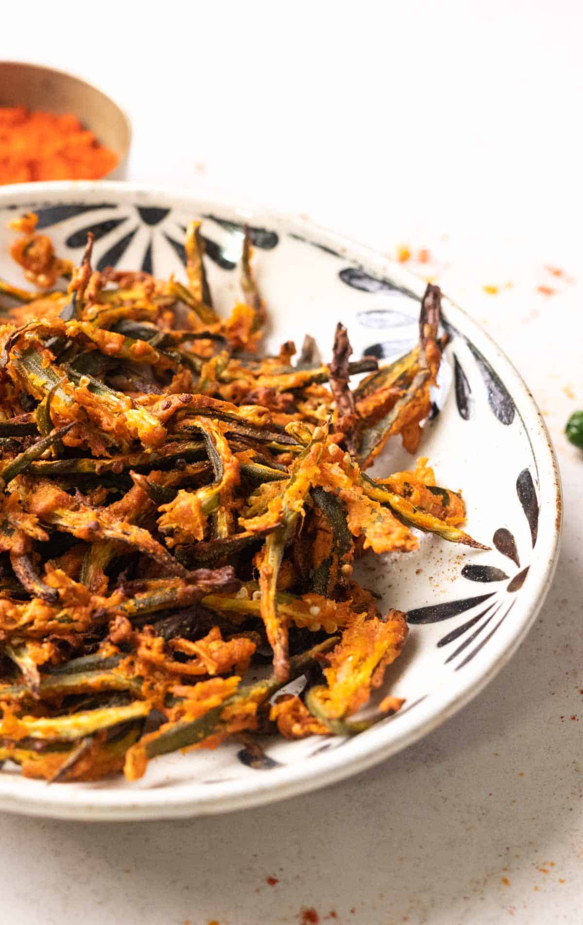 Air fried kurkuri bhindi in a white bowl