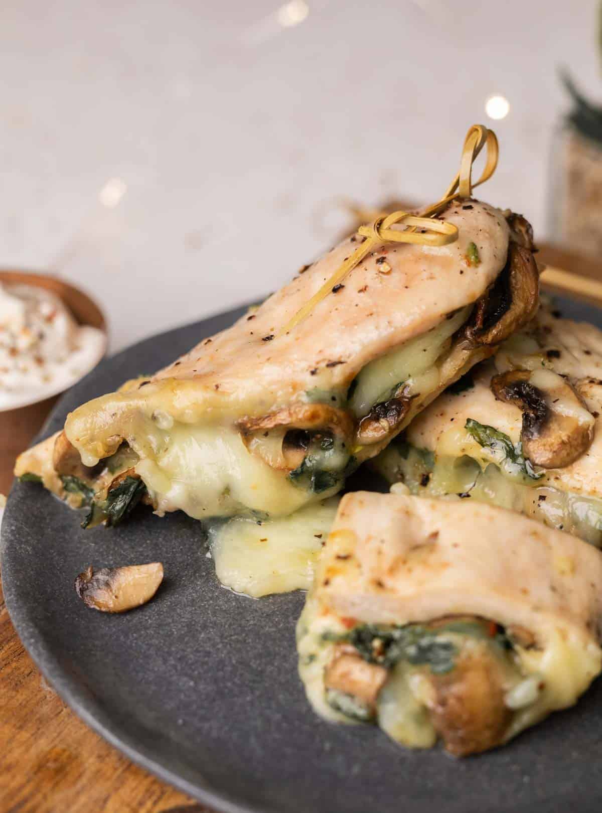 stuffed chicken breast served on a dark grey plate