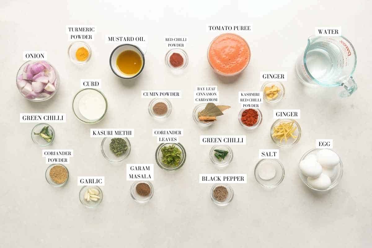 Picture of all the ingredients required for the Dhaba Egg Curry with text to identify them