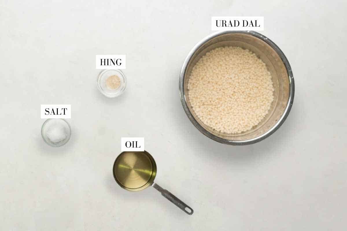 Picture of all the ingredients required for Dahi Vada with text to identify them