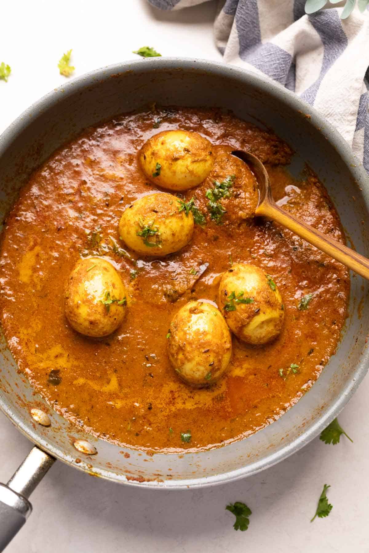 shot of egg curry in a grey pan