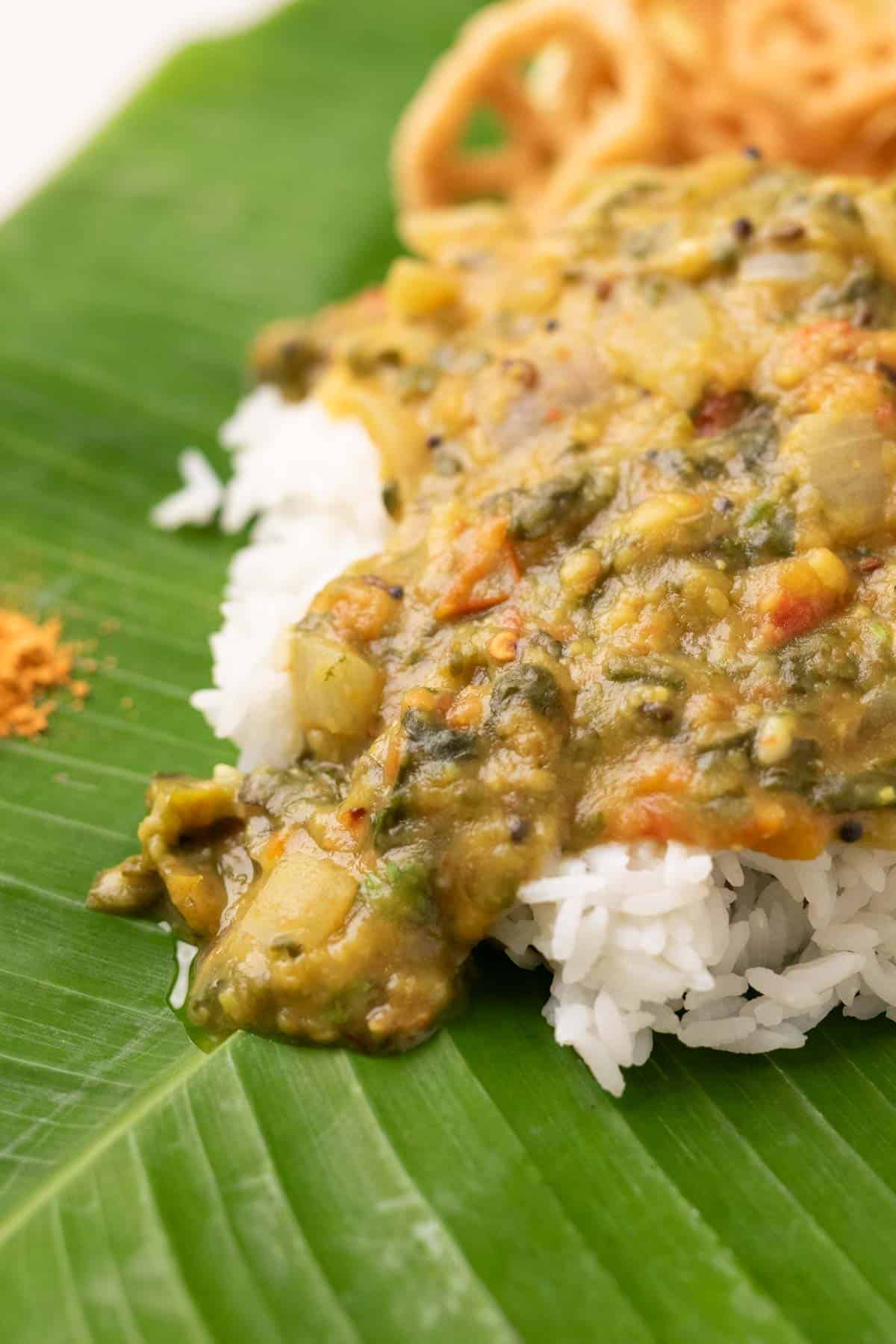 rice served on banana leaf with andhra pappu, with fryums and chutney podi