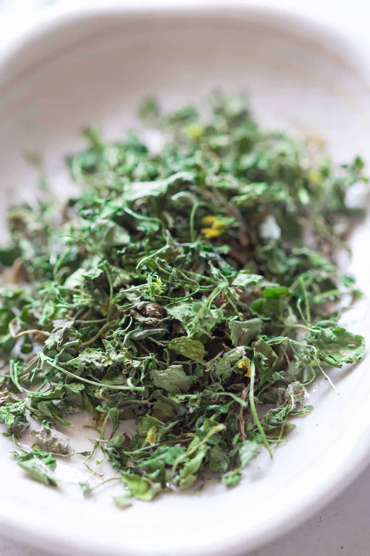 close up shot of kasuri methi on a white plate