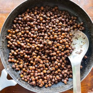 Kala chana pictured in the iron pan it was cooked in
