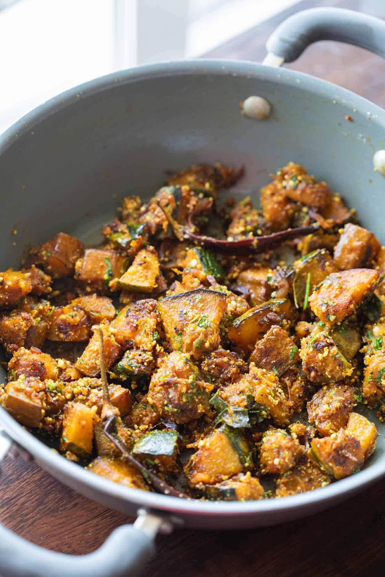 peanut pumpkin sabzi in a grey kadai garnish with coriander leavese