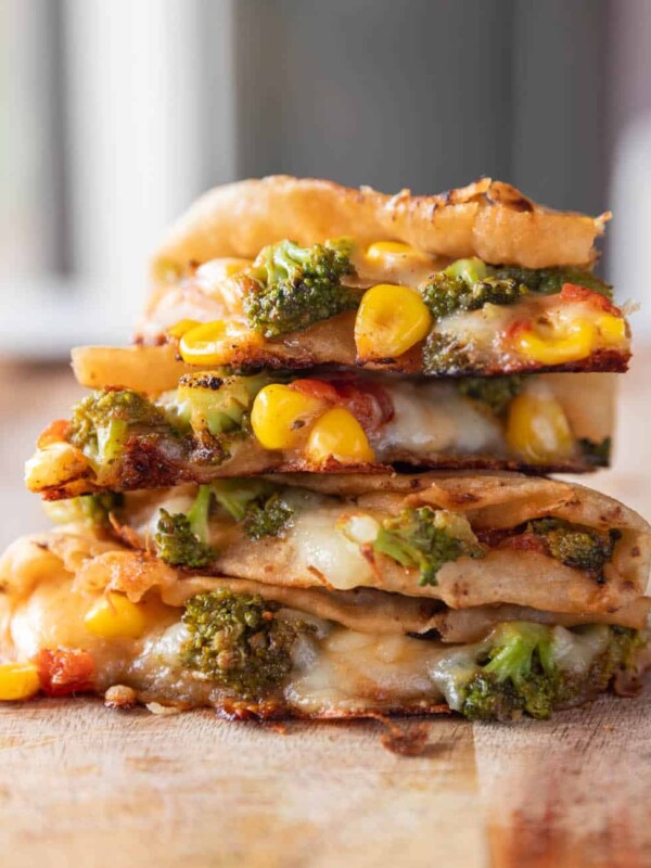a stack of broccoli corn quesadilla on a wooden table