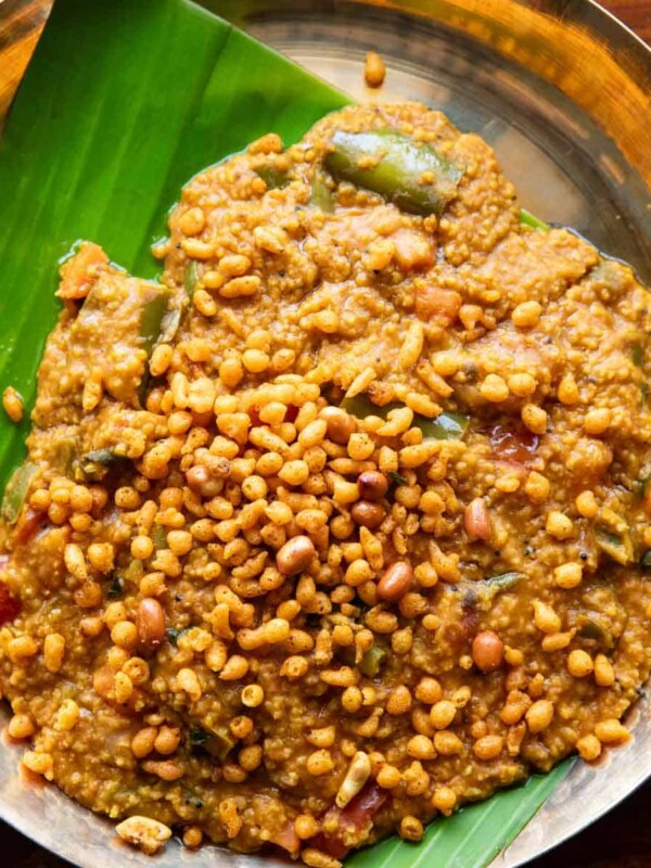 Millet bisi bele bath served on a plate lined with banana leaf
