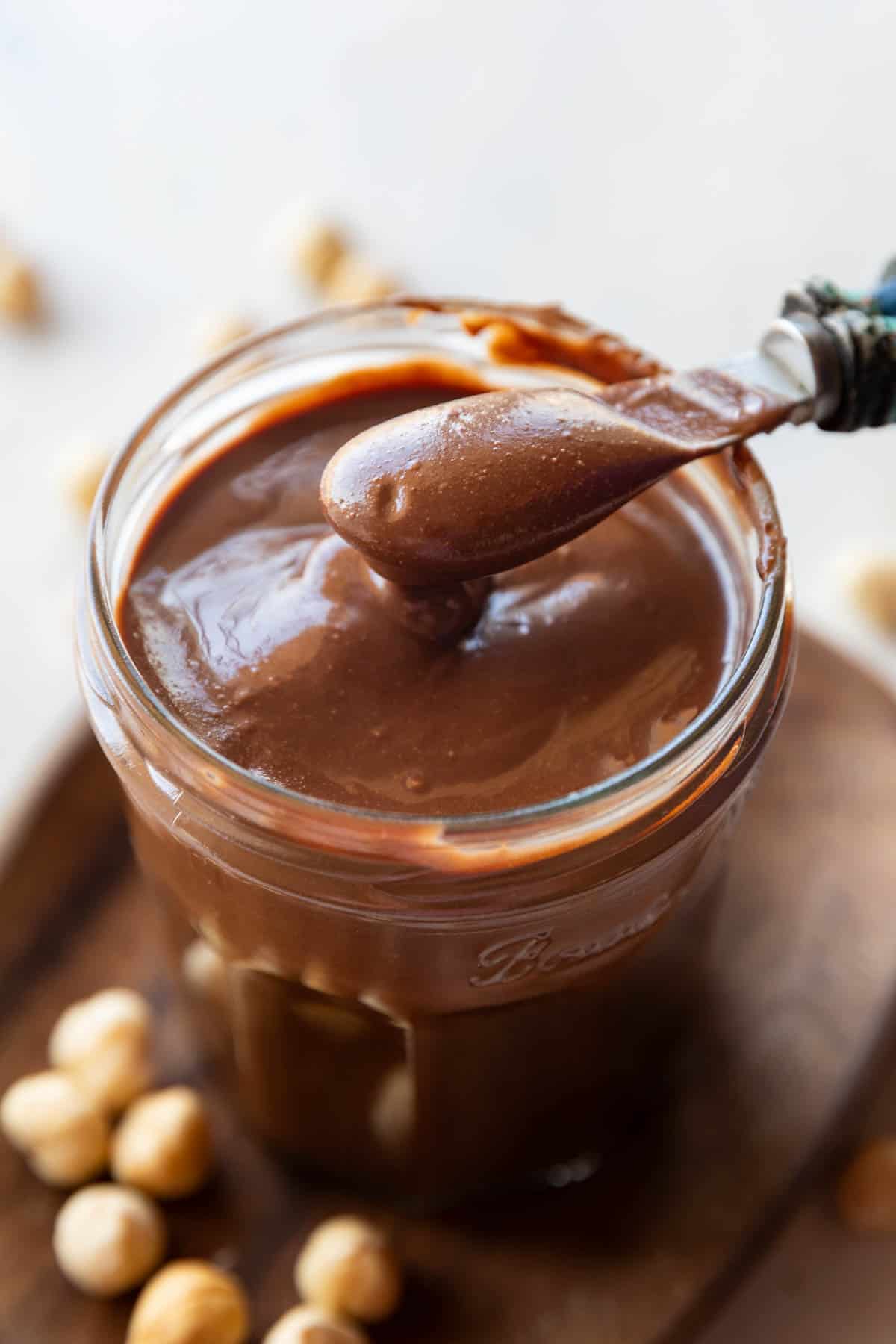 Homemade Nutella chocolate spread in a jar with spoon