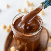 Homemade Nutella chocolate spread in a jar with spoon