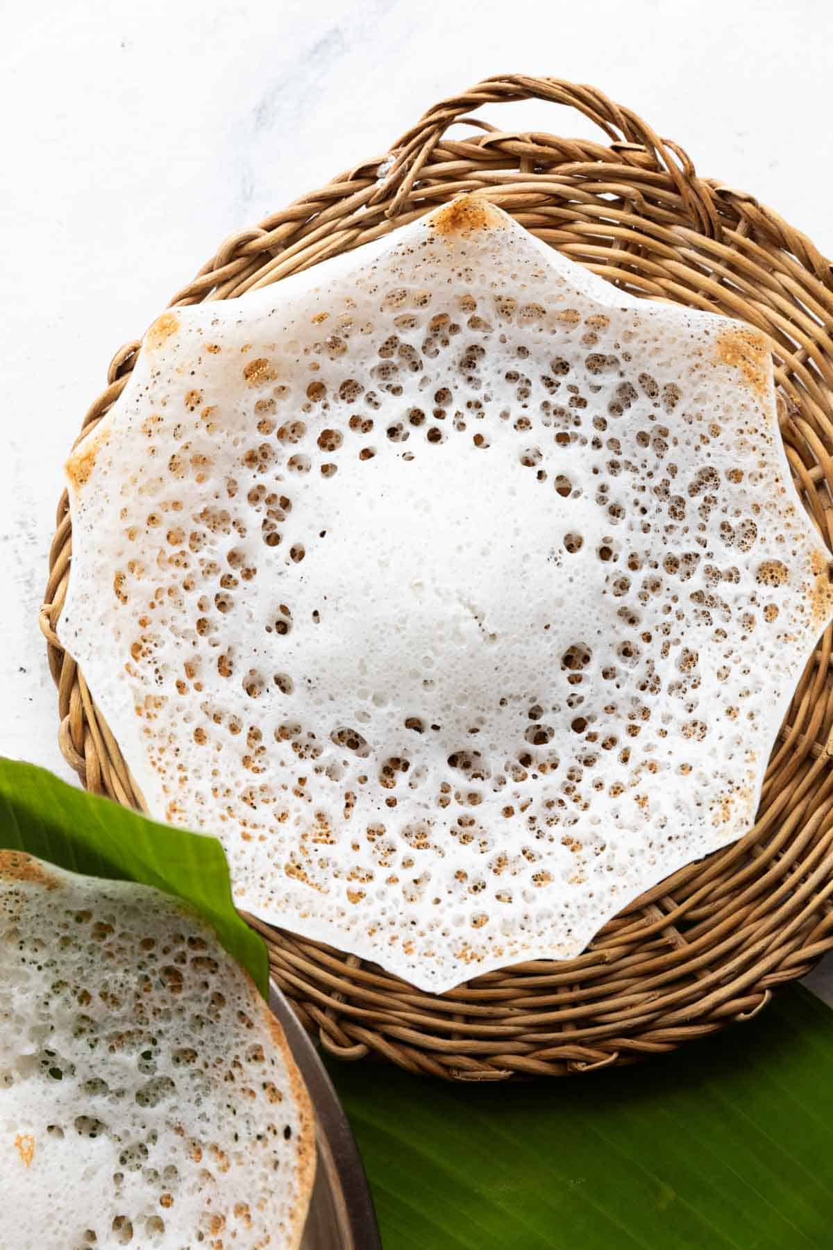 tender coconut appam in a wicker basket