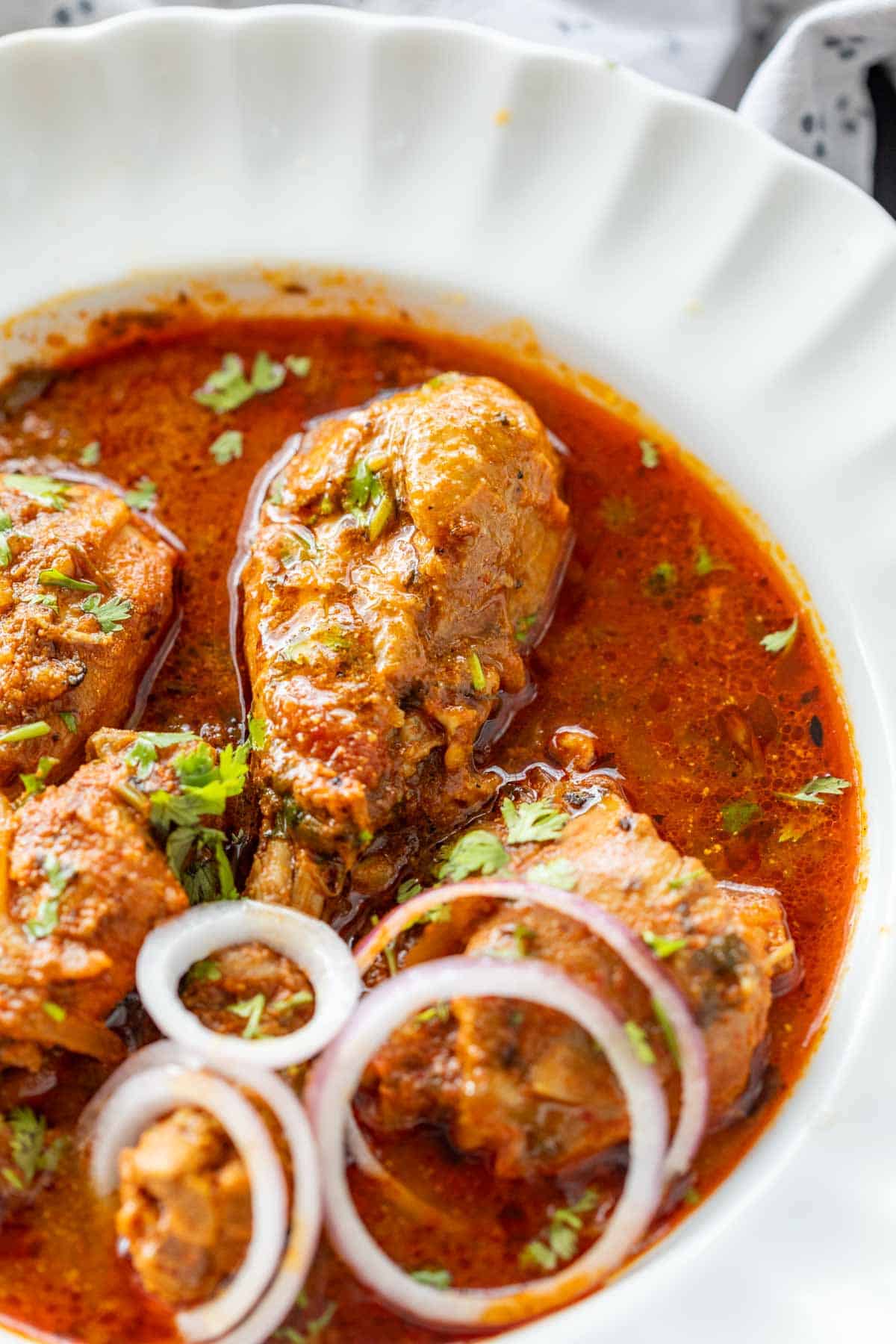 pressure cooker chicken curry served with sliced onion rings