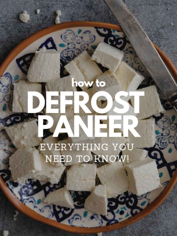 Fresh paneer cubes on a plate with a knife