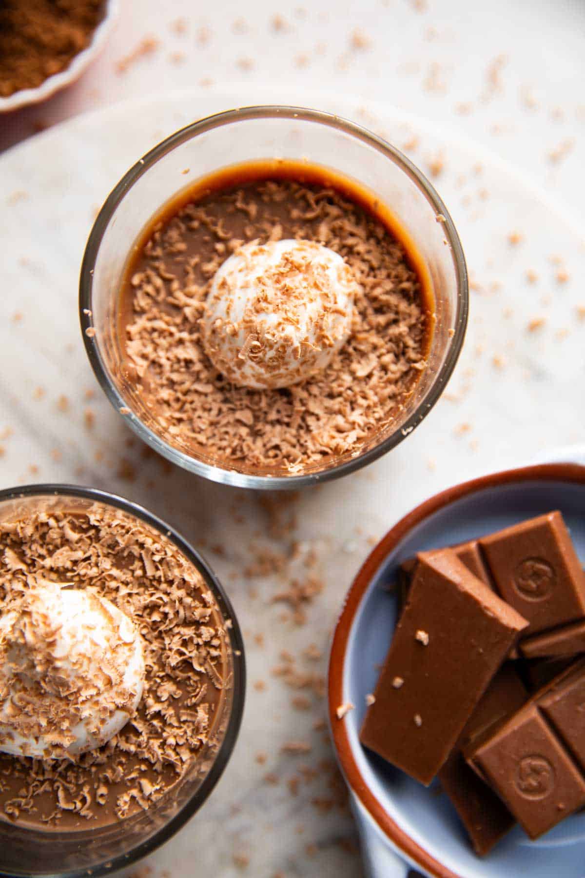 Paneer chocolate pudding garnished with cream and cocoa powder