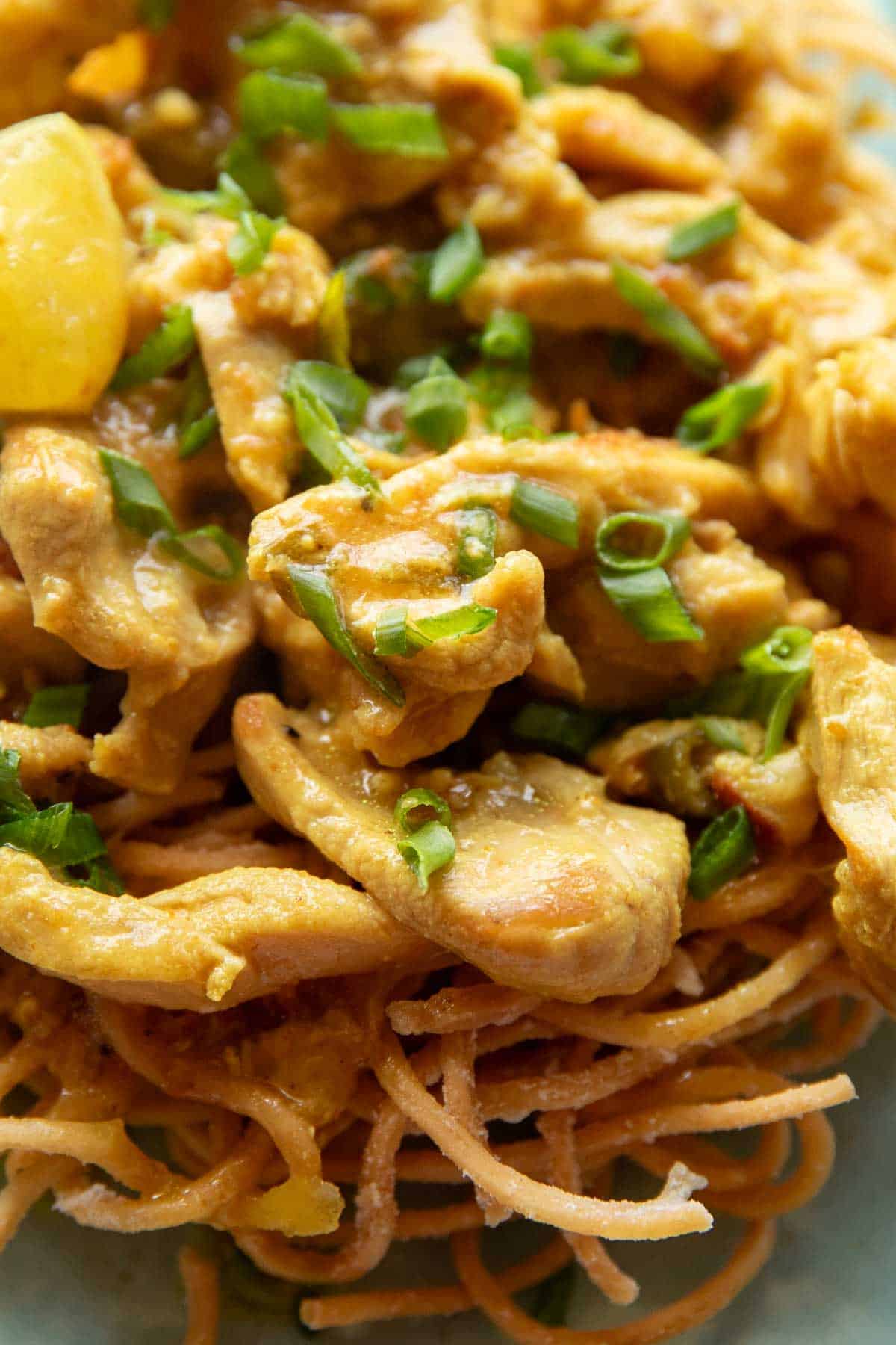 close up shot of lemon chicken served with fried noodles