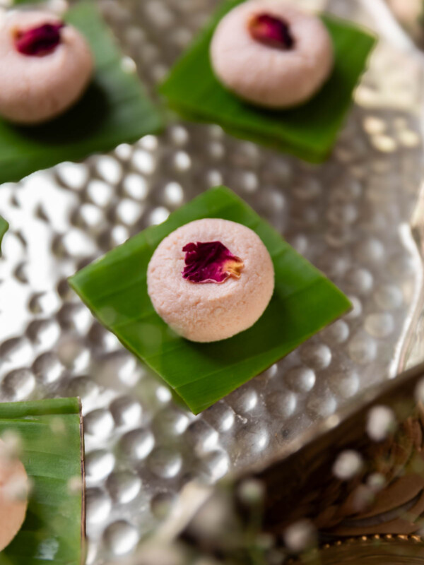 rose kacha golla garnished with dried rose petal and served on a leaf square