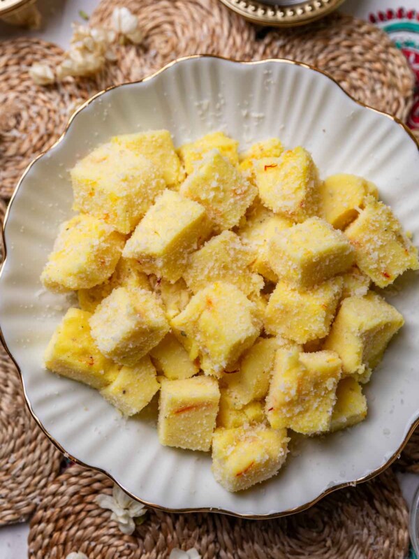 saffron milk pudding bites served in a white bowl
