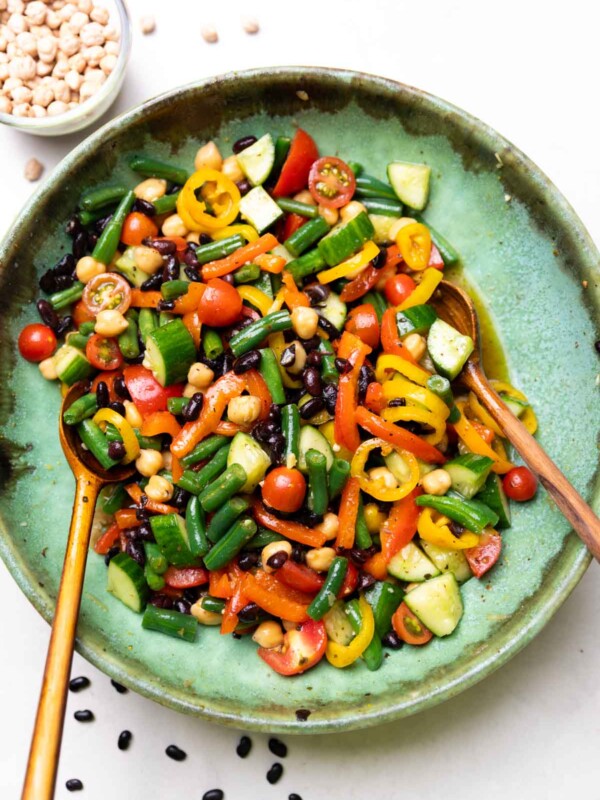 three bean salad served with wooden spoons
