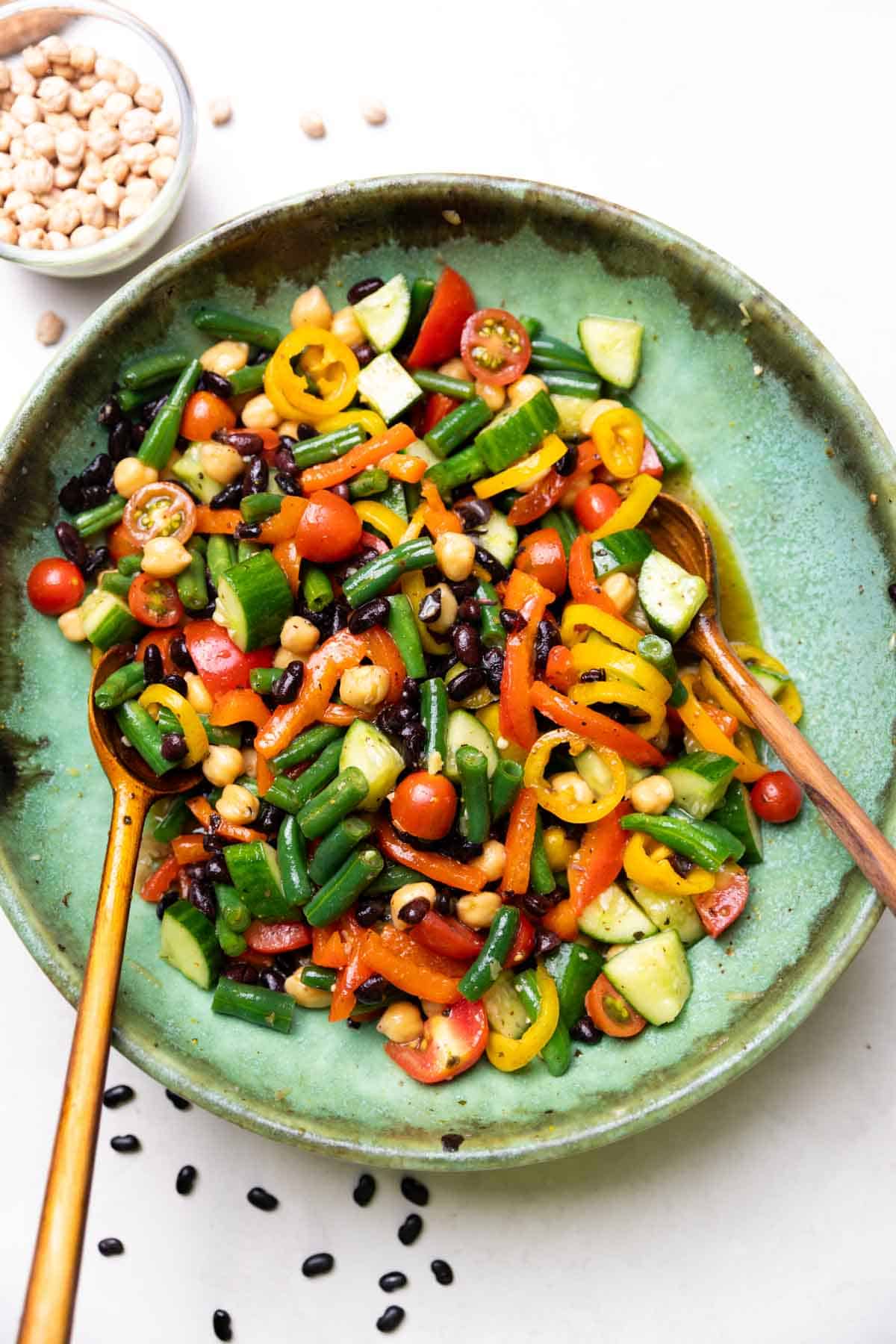 three bean salad served with wooden spoons