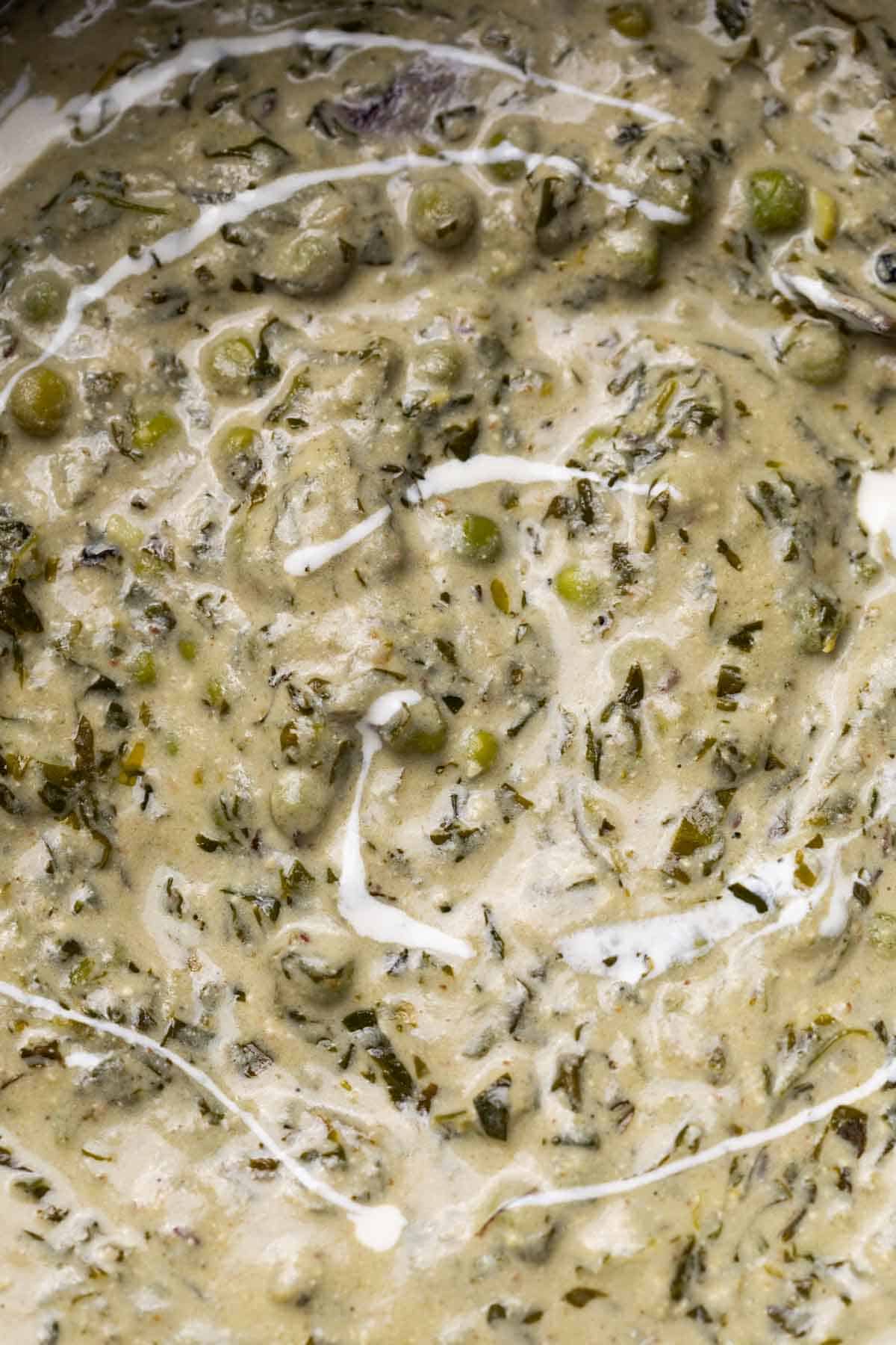 Close up of the texture and creaminess of methi matar malai