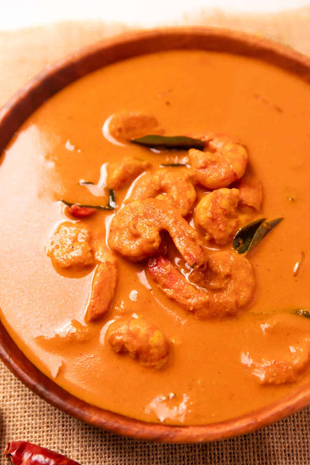mangalorean prawn curry served in a wooden bowl
