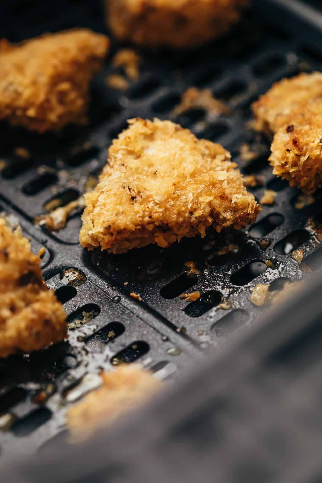 air fryer chicken nuggets cooking in an air fryer