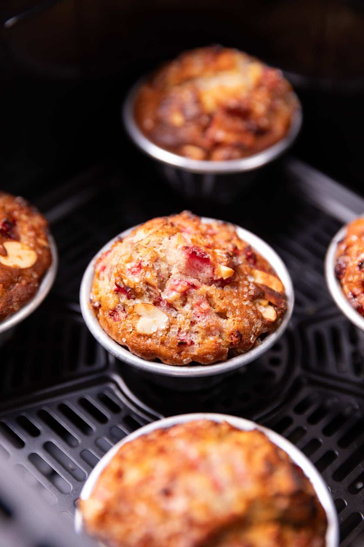 closeup image of freshly baked strawberry muffins in an air fryer