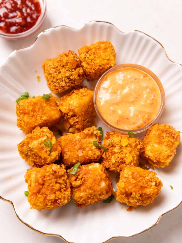 air fryer paneer popcorn served on a white plate with accompaniments