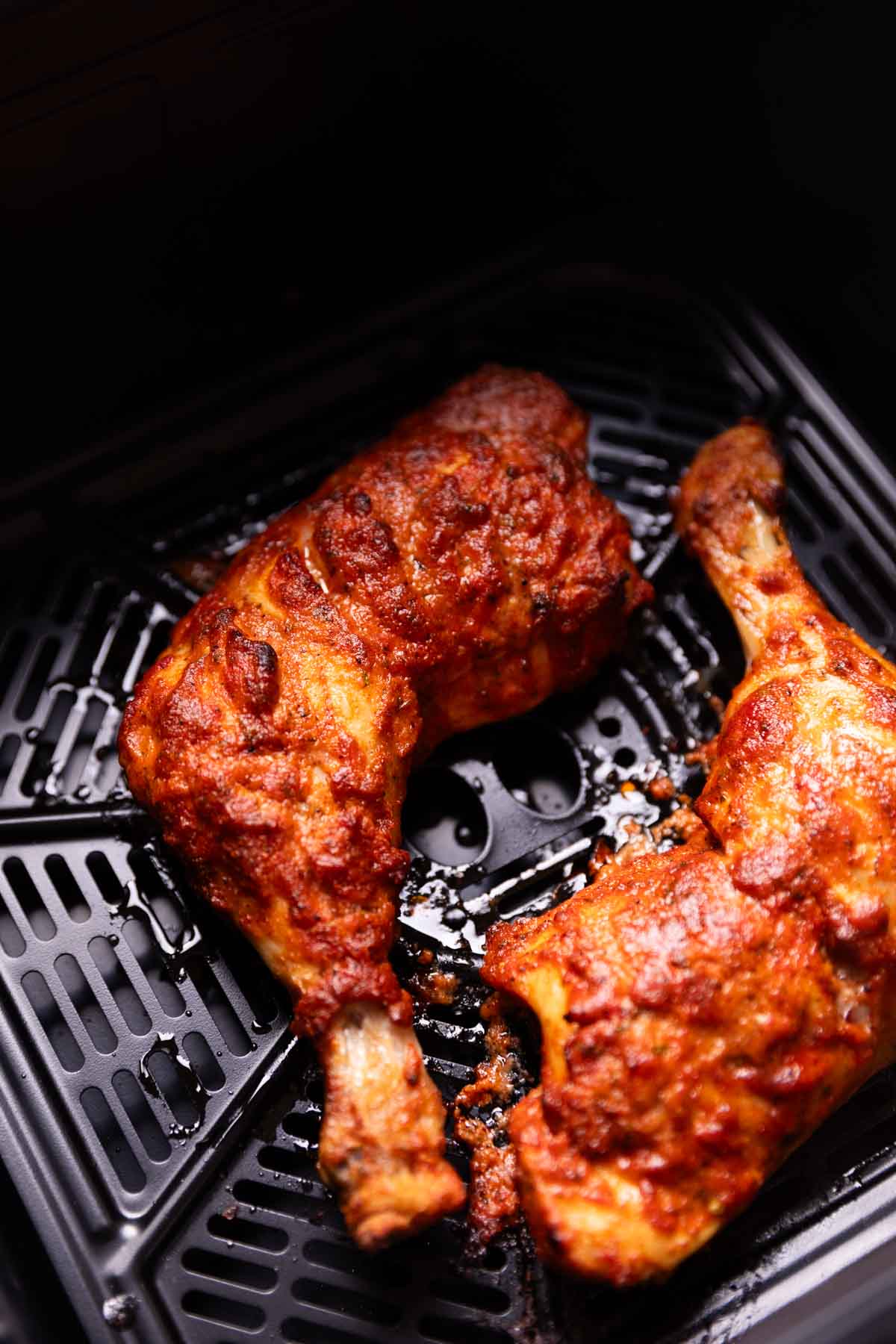 tandoori chicken being cooked in an air fryer