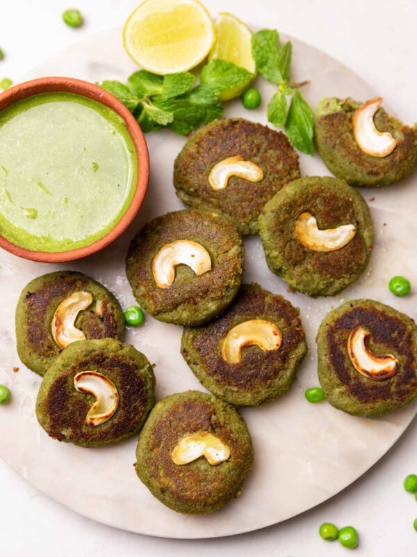 hara bhara kebabs served on a white round platter with accompaniments