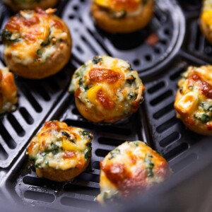 freshly baked air fryer stuffed mushroom lined up in the air fryer