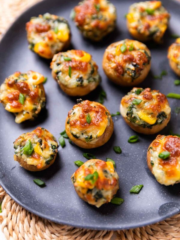 air fryer stuffed mushroom served on a black plate