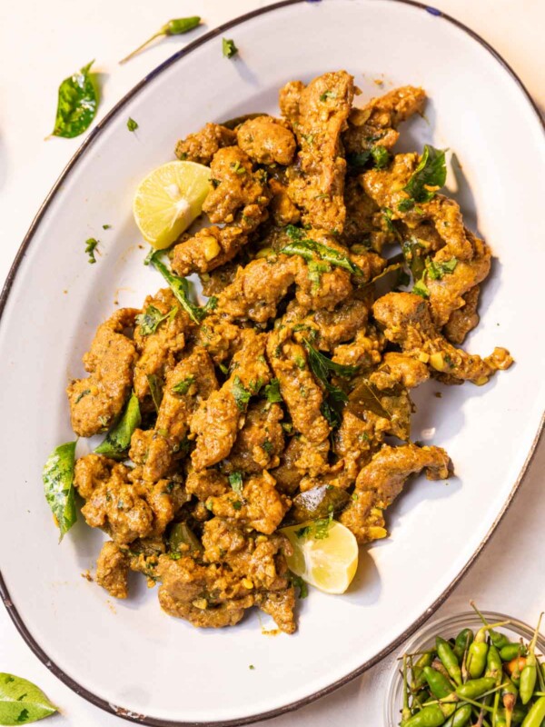 chicken majestic served on a white platter with accompaniments