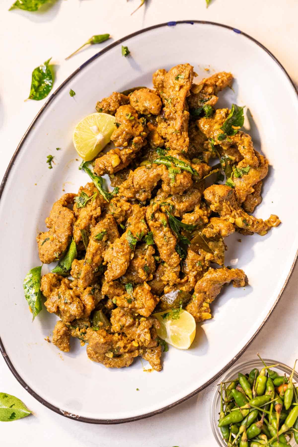 chicken majestic served on a white platter with accompaniments