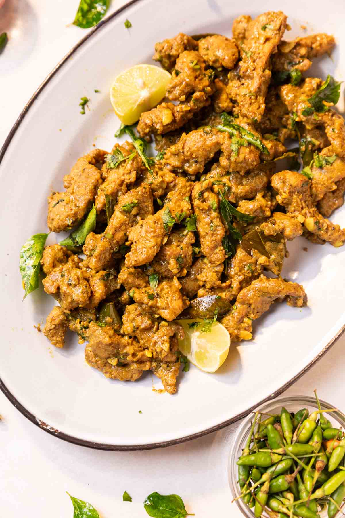 chicken majestic served on a white platter with accompaniments
