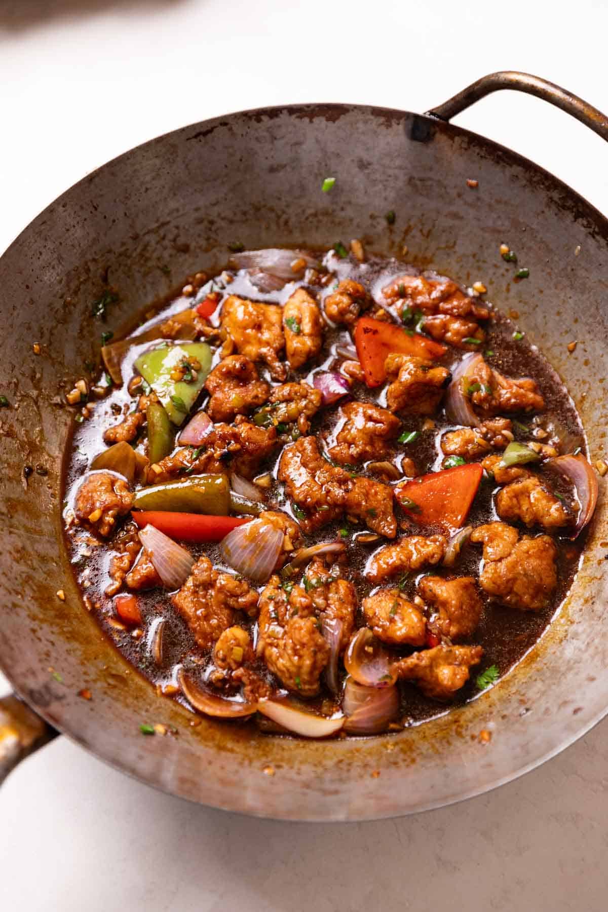 freshly cooked chicken manchurian in a wok, ready to be served