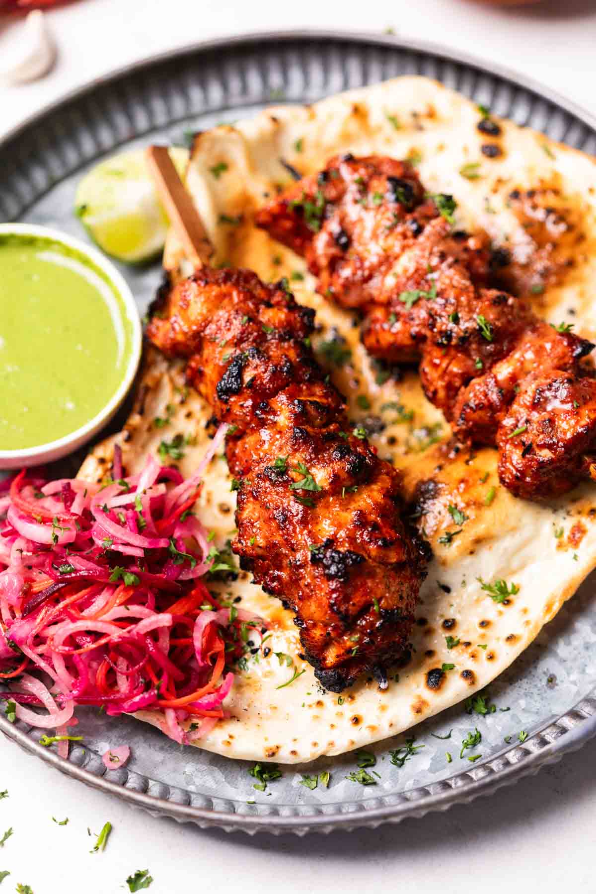 air fryer chicken tikka served on a naan with accompaniments