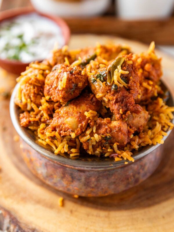 boneless chicken biryani served in a copper handi style bowl