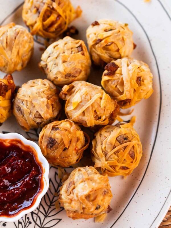 firecracker crispy potato balls served on a white plate with a dip