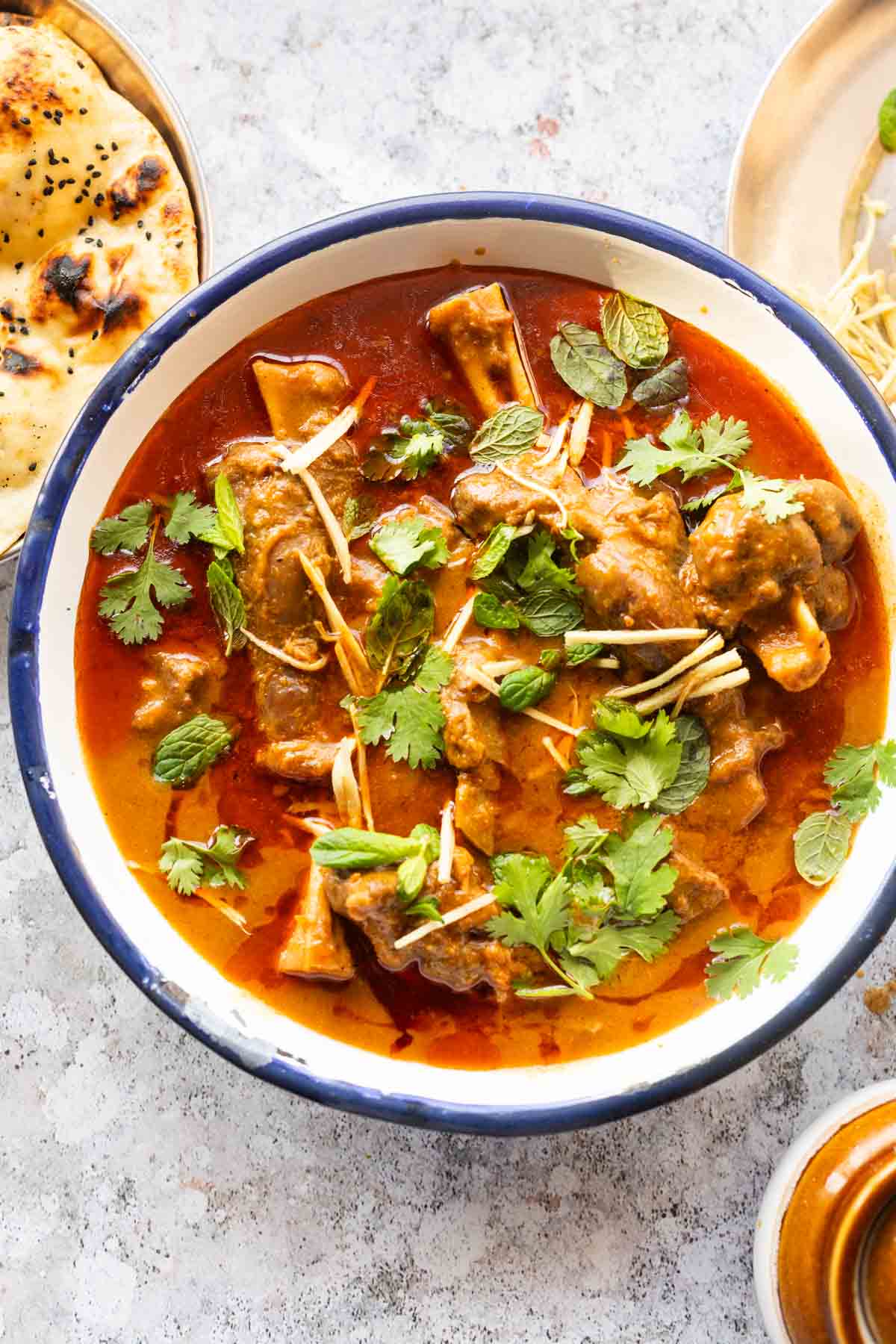mutton nihari served on a bowl and garnished with coriander and julienned ginger