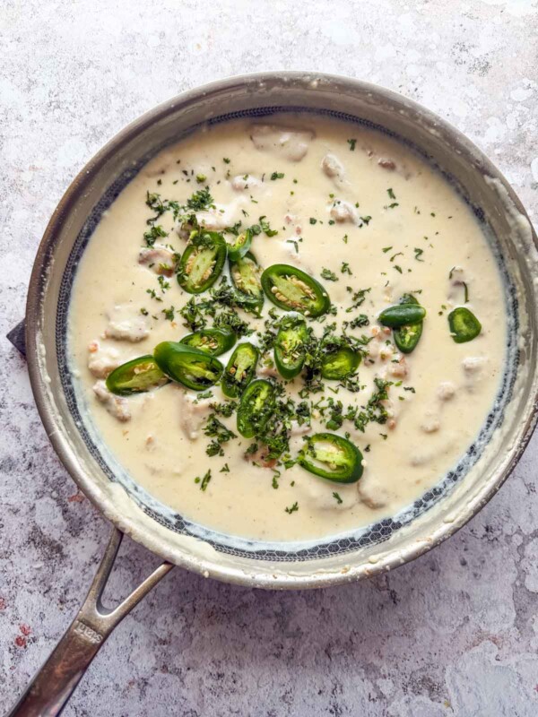 freshly made creamy japan chicken garnished with green chillis ready to be served