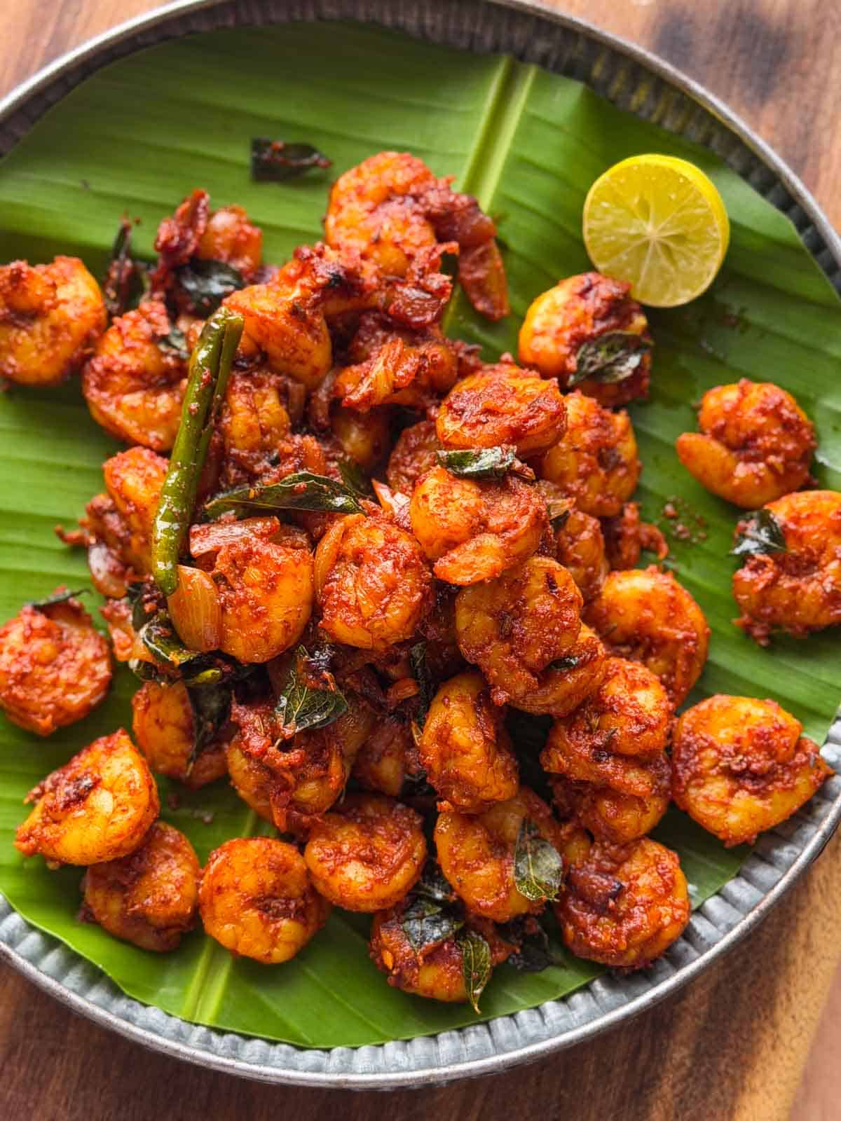 kerala prawn roast served over a banana leaf